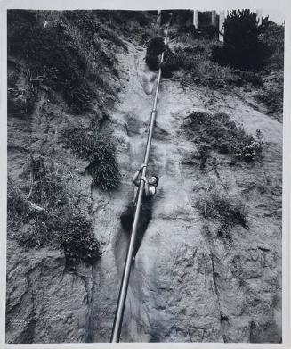 Boy Climbing a Pipe, CA
