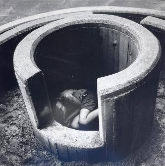 Boy Curled in Concrete Rings, NY
