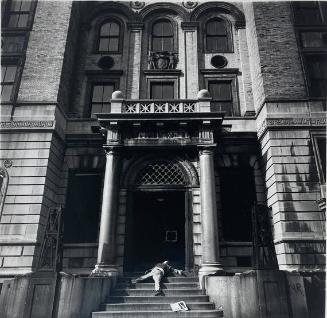 Older Man Lying on Stairs of Closed Police Station, NY, NY
