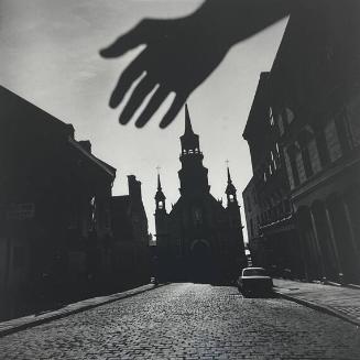 Silhouette of a Hand in Front of a Brick Street with a Church at the End, Quebec
