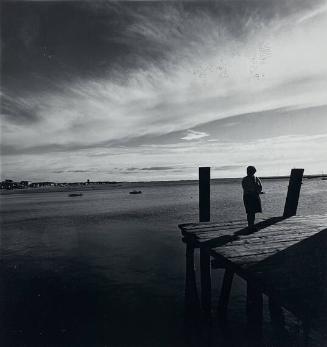 A Portuguese Fisherman's Wife Stands on the Pier Awaiting the Return of Her Husband, Cape Cod, MA
