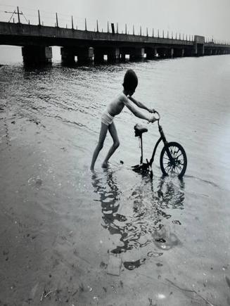 Boy with Bike in Water, Queens, NY
