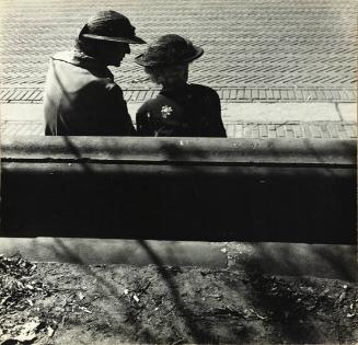 untitled (two ladies in hats chatting on bench in park)