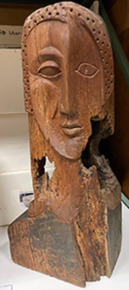 Beam end figure [head carved of slightly decomposed wood]