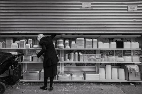 Woman Picking Food Container / Penn St, Brooklyn, NY