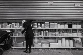 Woman Picking Food Container / Penn St, Brooklyn, NY