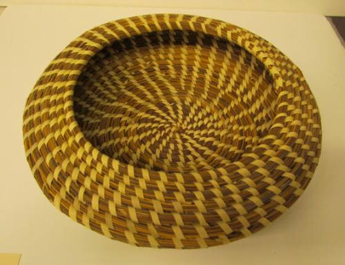 Gullah bowl shaped coil basket with cantilevered inward rim