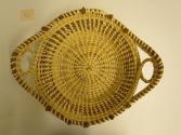 Gullah coil basket with two looped handles and rim studded with ten pine needle knots