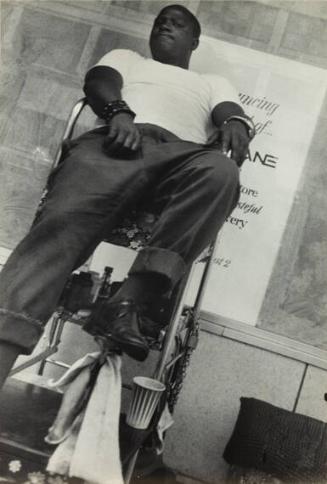 untitled (man in shoe shine chair)