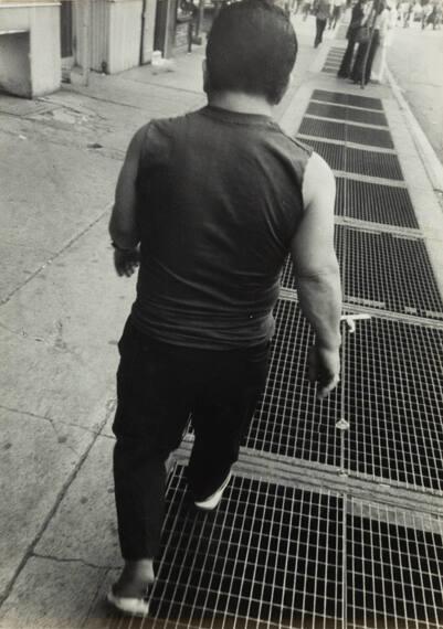 untitled (rear view of man walking on the street)
