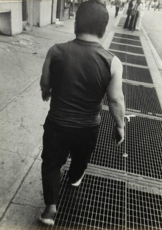 untitled (rear view of man walking on the street)