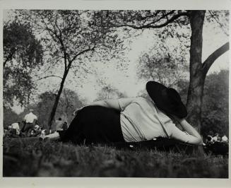 Central Park (woman with large black hat resting on the grass)