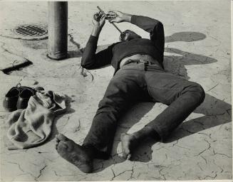 untitled (man lying down, playing flute)