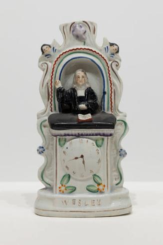 John Wesley in the pulpit with black robe