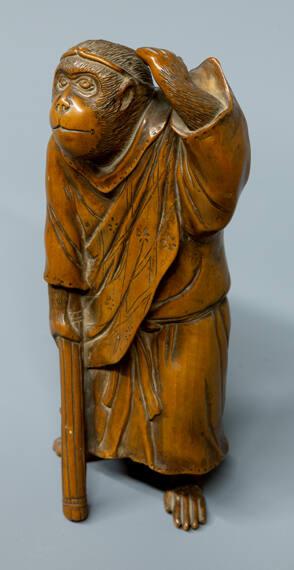 Chinese Wood Carving of Standing Monkey with Wrapped Bamboo Staff, and Left Arm over Head