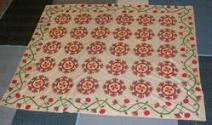 Summer quilt or quilt top with pattern of red and green flowers