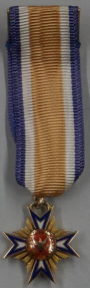 Three miniature insignia of non-Russian orders suspended on ribbons with their respective colors
